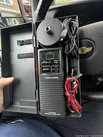 Open carry case showing radio, antenna, cords