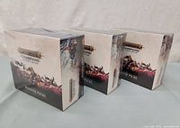 Three sealed booster boxes side view