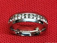 Titanium band ring showing top of band with clear stones