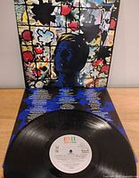 Front cover opened with vinyl and inner sleeve artwork visible