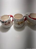 Front view of three face mugs