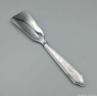 Full view of sterling silver shoe horn, horn side up