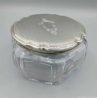 Closed jar showing sterling lid and faceted body
