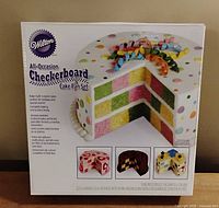 Front view of boxed Wilton All-Occasion Checkerboard Cake Pan Set