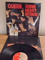 Front cover of Queen Sheer Heart Attack jacket with vinyl partially removed