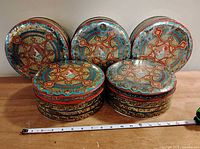 Front view of all five tins showing lids’ ornate pattern