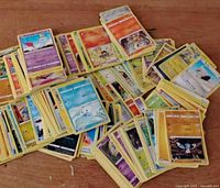 Pile of yellow-border Pokémon cards spread on table