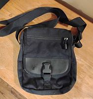 Front view of black MEC shoulder bag with strap