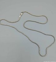 Full view of sterling rope chain laid out showing length and clasp
