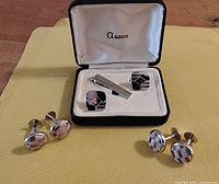Boxed Auseco set with tie bar and rectangular cufflinks, plus two pairs of round cufflinks displayed