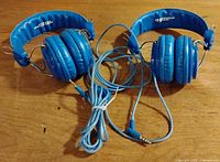 Two blue Hamilton Buhl headphones laid out showing headbands, earcups and cords