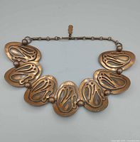 Front view showing plaque design and beads