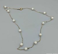 Full view of gold-filled chain necklace with faux pearls
