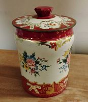 Front view of floral toffee tin showing pattern and shape