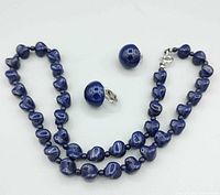 necklace and both earrings close-up showing bead shape, clasp, clip hardware