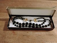 Necklace in original gift box, showing bead arrangement and clasp