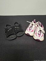 Both pairs of toddler shoes side by side