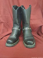 Front view of both boots showing leather uppers and harness straps