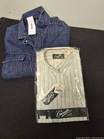 Folded denim overshirt with tag and sealed Crocodile dress shirt