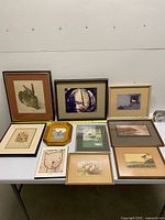 Group shot of all framed artworks laid on table