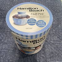 Retail cylindrical box showing product and branding