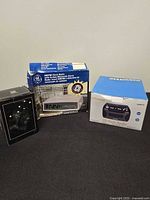 Group shot of the three boxed items on black surface