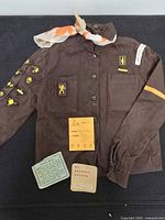 Full view of uniform shirt, neck scarf, and record cards