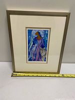Full view of framed print with tape measure showing width