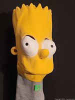 Front view of yellow Bart Simpson latex mask showing facial features