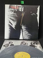 Front cover showing printed zipper jean artwork with record and inner sleeve visible