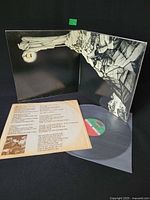 Gatefold open showing inner artwork, lyric sleeve and vinyl record