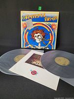 Front view showing gatefold jacket cover, both translucent LPs and booklet