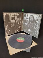 Gatefold open showing interior collage and record on inner sleeve