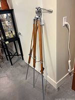 Full view of wooden survey tripod standing