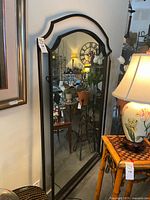 Front view of full-length arched mirror, shows frame and size