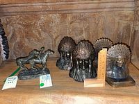 Overall lot showing horse sculpture and three bronze Indigenous chief bookends