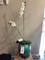 Full view showing jardinière on stand with faux orchid