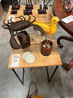 Front view of crab and bird sculptures on table