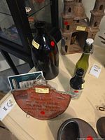 Group shot showing plaque and three bottles