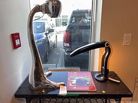 Overall lot with both lamps and book on table