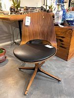 Full view of walnut swivel chair