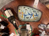 Overall lot view showing platter, wine bottle and wrought iron stand