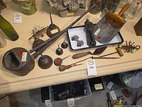 overhead view of entire lot showing ladles, oilers, oil can, scoop, hooks, screwdriver and cast pieces