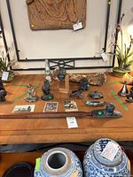 Table view showing pipe, canoe, postcards, bronze casts