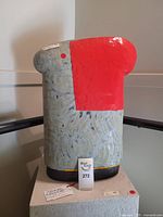 Full view of glazed ceramic torso sculpture on pedestal