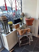 group view showing pedestals, vases, lamp, planter, corbel, table