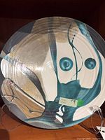 Front of Raku plate showing glaze design