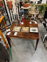 Full view of rectangular side table with wood grain top and square legs