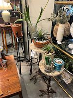 Group shot of four plant stands with planters and plants