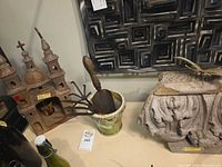 Church sculpture, planter with tools, corbel fragment together